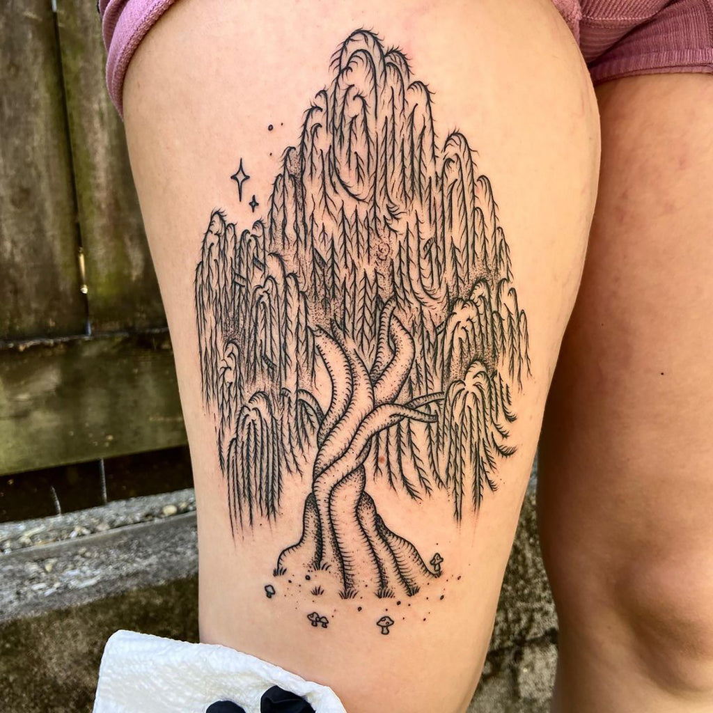 Pine tree forest tattoo on the left upper arm.